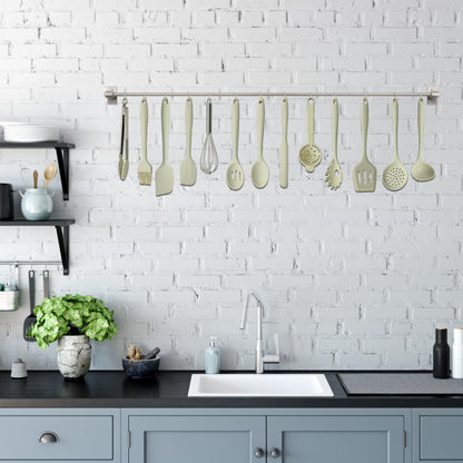 Beige spatula resting in red crab-shaped spoon holder on modern countertop

