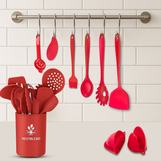 Red silicone kitchen utensils set with crab spoon holder on white background

